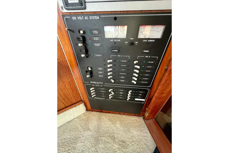 Slide: The Image of Control panel of 1985 Tollycraft 48 Cockpit Motor Yacht, featuring 120-volt AC system. - 54
