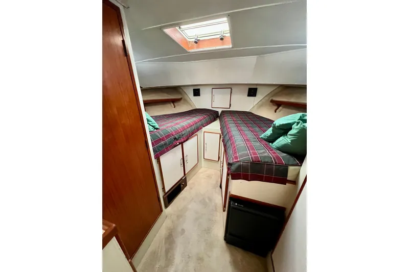 Slide: The Image of 1985 Tollycraft 48 Cockpit Motor Yacht cabin with twin beds and overhead skylight. - 72