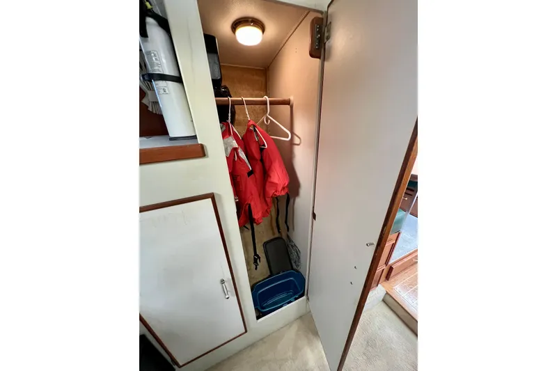 Slide: The Image of Closet interior of 1985 Tollycraft 48 Cockpit Motor Yacht with red jackets and storage. - 76