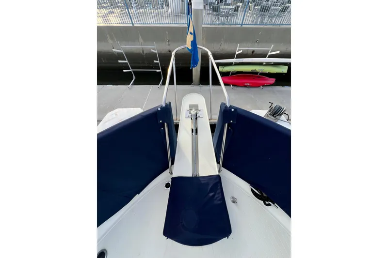 Slide: The Image of 1985 Tollycraft 48 Cockpit Motor Yacht with blue seating and dock view. - 8