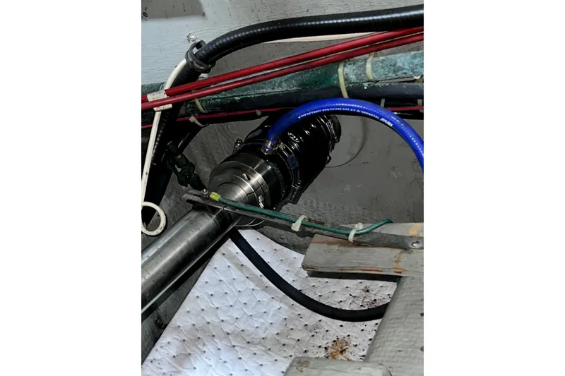 Slide: The Image of Engine compartment of 1985 Tollycraft 48 Cockpit Motor Yacht with visible hoses and fittings. - 86
