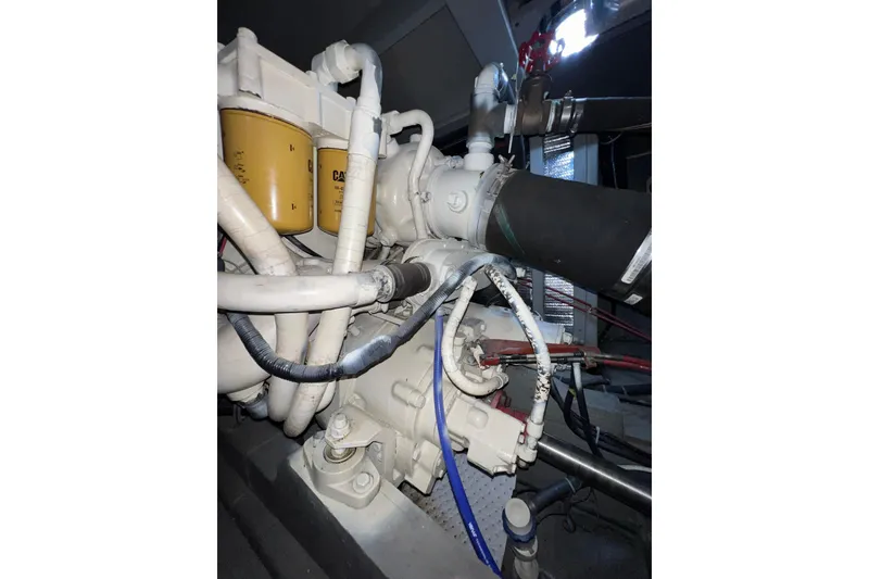 Slide: The Image of Engine compartment of 1985 Tollycraft 48 Cockpit Motor Yacht, featuring pipes and filters. - 89