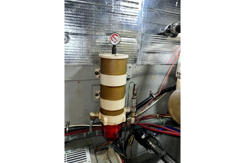 Slide: The Image of Engine room of 1985 Tollycraft 48 Cockpit Motor Yacht with fuel filter system. - 93