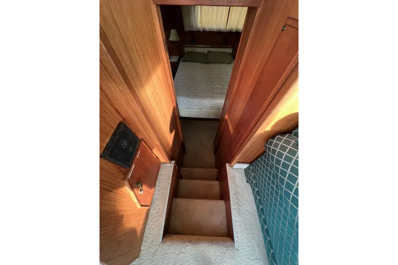 Slide: The Image of Stairway leading to cozy bedroom in 1985 Tollycraft 48 Cockpit Motor Yacht. - 96