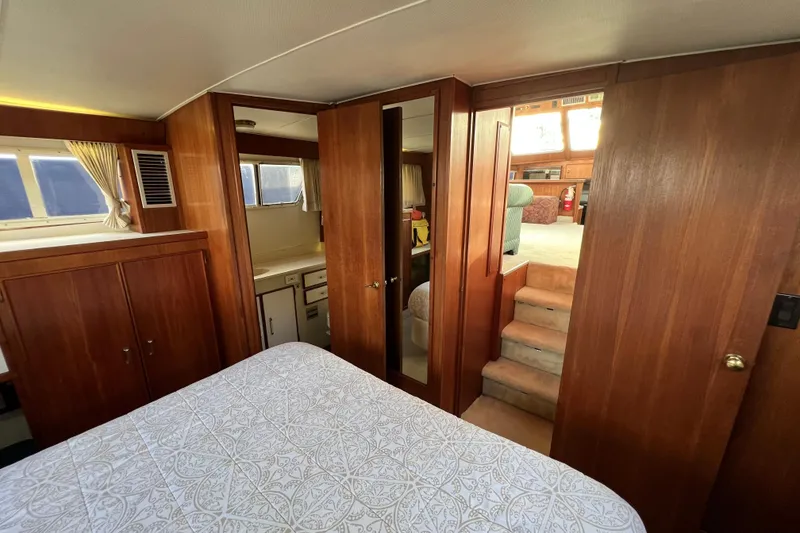 Slide: The Image of Interior of 1985 Tollycraft 48 Cockpit Motor Yacht with wood paneling and cozy furnishings. - 99