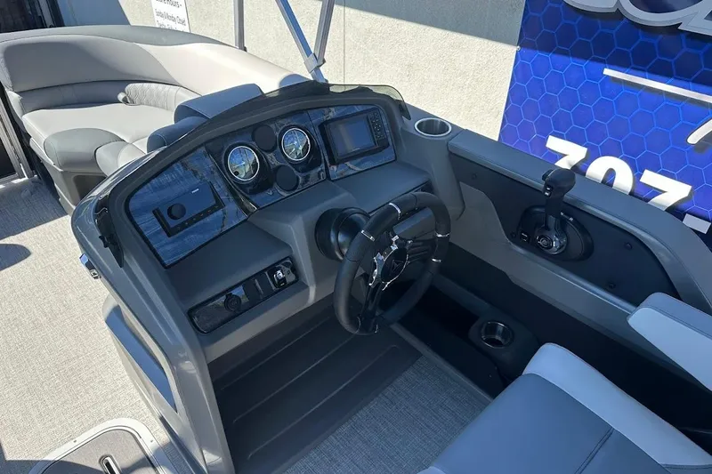Slide: The Image of 2026 Tahoe Pontoon LTZ Quad Lounger Shift 23 dashboard with modern controls and seating. - 13