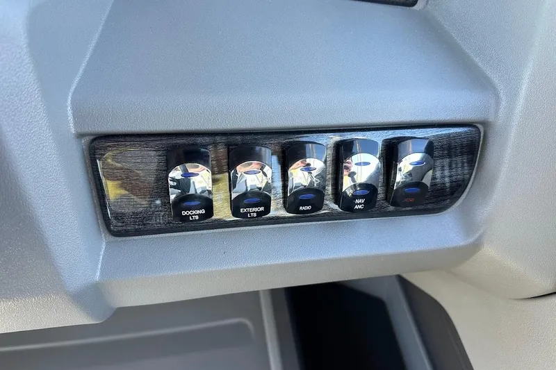 Slide: The Image of Control panel of 2026 Tahoe Pontoon LTZ Quad Lounger Shift 23 with labeled switches. - 16
