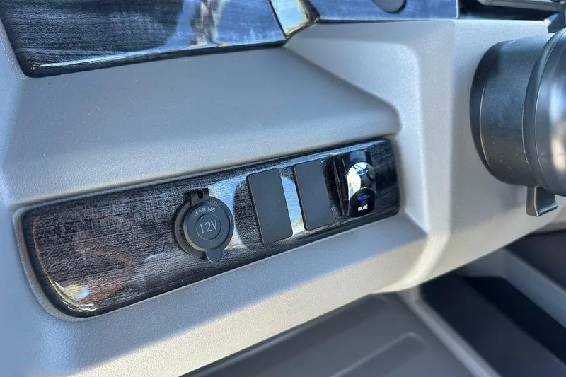 Slide: The Image of Dashboard controls of 2026 Tahoe Pontoon LTZ Quad Lounger Shift 23 with 12V marine outlet. - 17