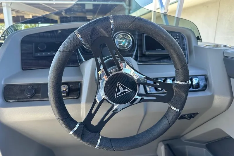 Slide: The Image of Steering wheel of 2026 Tahoe Pontoon LTZ Quad Lounger Shift 23, featuring modern dashboard controls. - 18