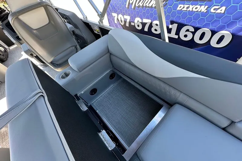 Slide: The Image of 2026 Tahoe Pontoon LTZ Quad Lounger Shift 23 interior seating with storage compartment. - 25