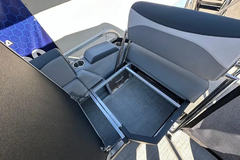 Slide: The Image of 2026 Tahoe Pontoon LTZ Quad Lounger Shift 23 interior seating with storage compartment. - 26