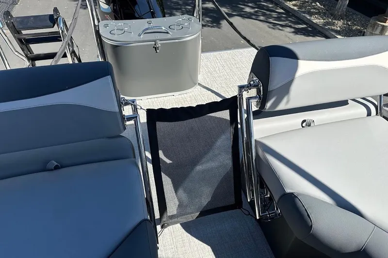 Slide: The Image of 2026 Tahoe Pontoon LTZ Quad Lounger Shift 23 interior with gray seating and deck view. - 27