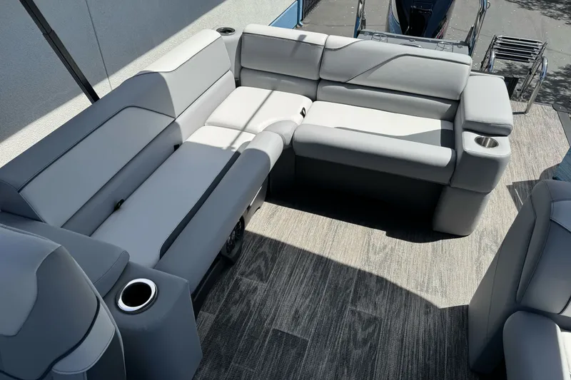Slide: The Image of 2026 Tahoe Pontoon Sport 85 Elite Windshield 25 interior with plush gray seating and cup holders. - 16