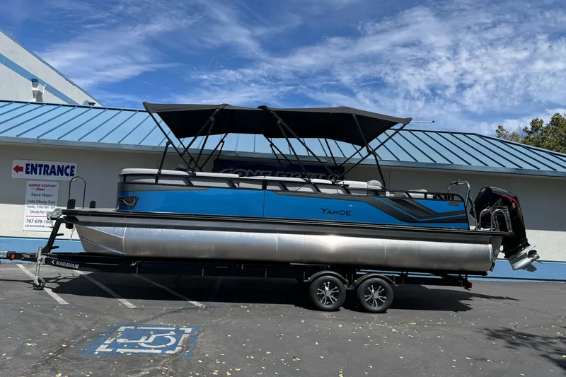 The Image of 2026 Tahoe Pontoon Sport 85 Elite Windshield 25 on trailer, parked outside building. - 0