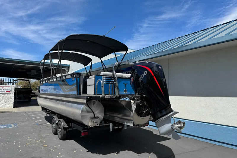 Slide: The Image of 2026 Tahoe Pontoon Sport 85 Elite Windshield 25 on trailer, parked outdoors. - 4