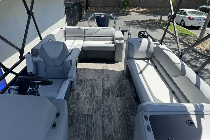Slide: The Image of 2026 Tahoe Pontoon Sport 85 Elite Windshield 25 interior with gray seating and wood flooring. - 6