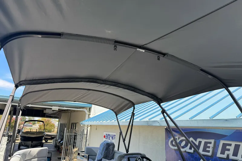 Slide: The Image of 2026 Tahoe Pontoon Sport 85 Elite Windshield 25 with canopy, docked at marina. - 19