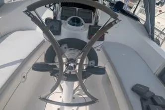 Slide: The Image of 2004 Hunter 33 yacht cockpit with steering wheel and navigation instruments. - 13