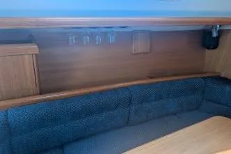 Slide: The Image of Interior of 2004 Hunter 33 sailboat with wooden cabinetry and cushioned seating. - 17