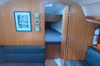 Slide: The Image of Interior of a 2004 Hunter 33 sailboat with cozy cabin and wooden paneling. - 18