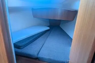 Slide: The Image of 2004 Hunter 33 sailboat cabin interior with cozy bedding and wooden accents. - 20