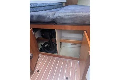 Slide: The Image of Interior view of a 2004 Hunter 33 sailboat, featuring open storage compartments. - 21