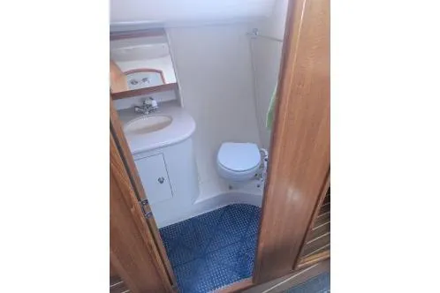 Slide: The Image of Compact bathroom in 2004 Hunter 33 sailboat with sink, toilet, and mirror. - 25