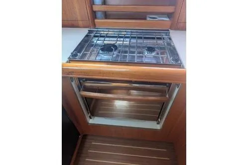 Slide: The Image of 2004 Hunter 33 yacht kitchen with stove and oven. - 34