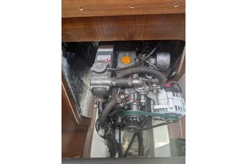 Slide: The Image of 2004 Hunter 33 engine compartment with visible mechanical components and wiring. - 36