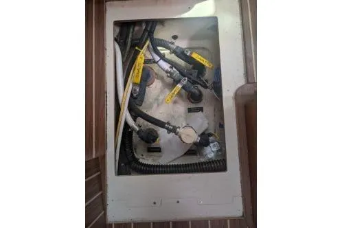 Slide: The Image of Engine compartment of a 2004 Hunter 33 sailboat, showing wiring and hoses. - 38