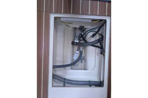Slide: The Image of Interior compartment of a 2004 Hunter 33 boat showing bilge pump and hoses. - 39