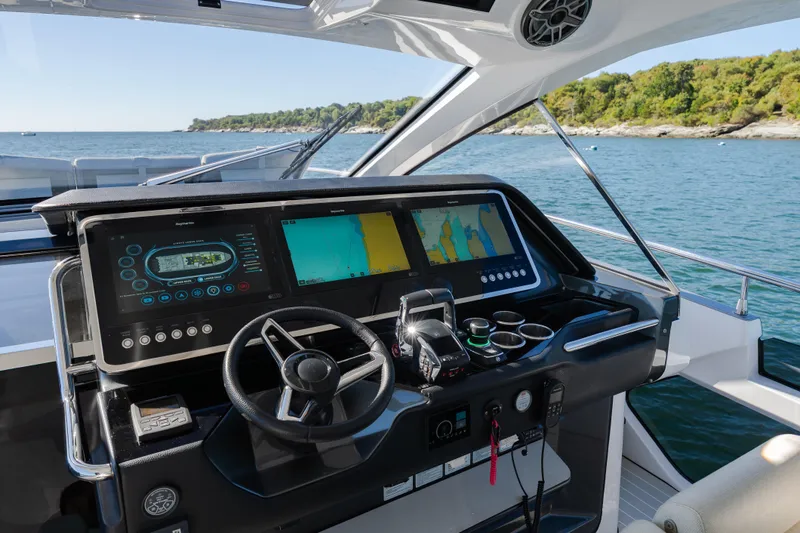 Slide: The Image of Cockpit of 2023 Azimut Verve 47 yacht with advanced navigation displays and steering wheel. - 18