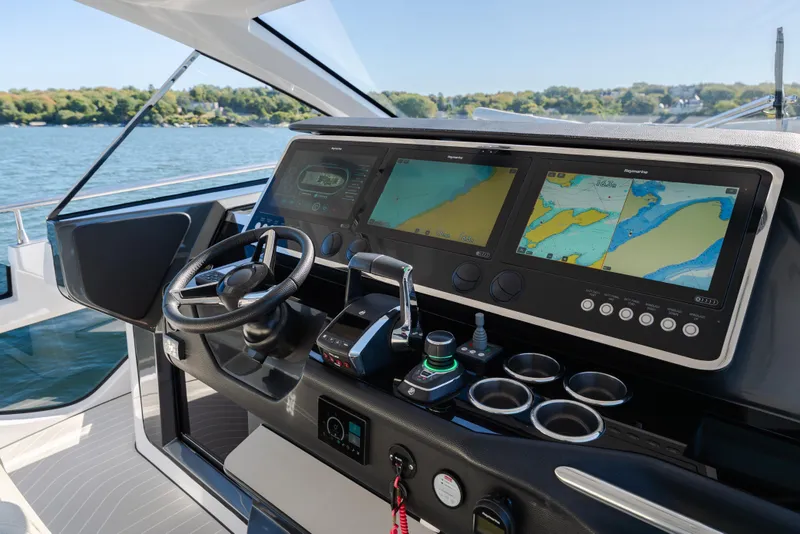 Slide: The Image of 2023 Azimut Verve 47 yacht cockpit with advanced navigation displays and controls. - 19
