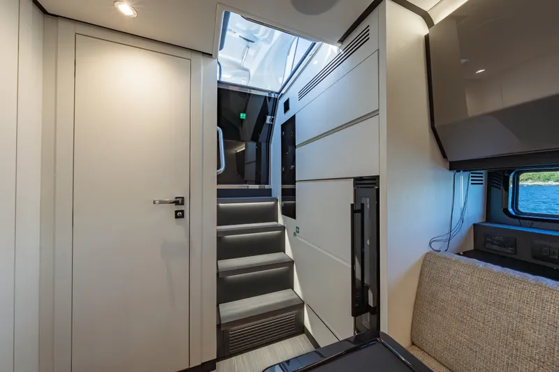 Slide: The Image of Interior of 2023 Azimut Verve 47 yacht, featuring modern design and elegant staircase. - 22