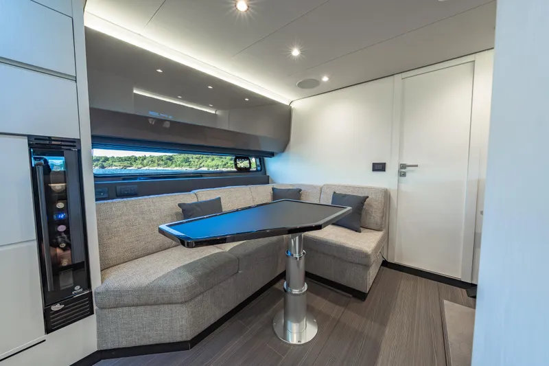 Slide: The Image of Luxurious interior of 2023 Azimut Verve 47 yacht with modern seating and sleek table design. - 23