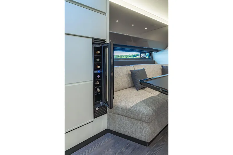 Slide: The Image of Luxurious interior of 2023 Azimut Verve 47 yacht with wine storage and cozy seating area. - 24