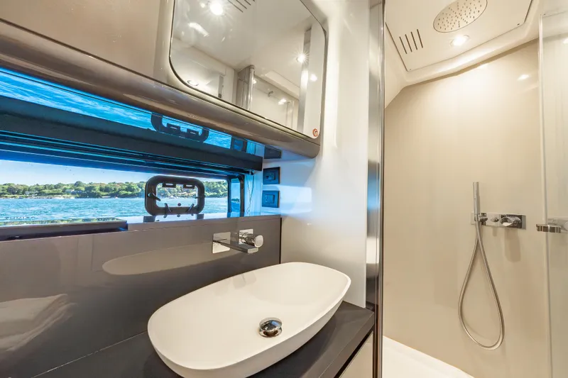 Slide: The Image of Luxurious bathroom interior of 2023 Azimut Verve 47 yacht with modern fixtures and scenic window view. - 28