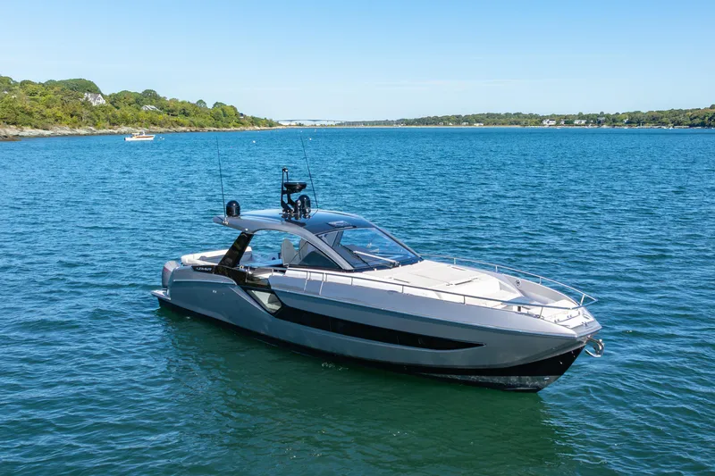 Slide: The Image of 2023 Azimut Verve 47 yacht cruising on a serene blue lake under a clear sky. - 3