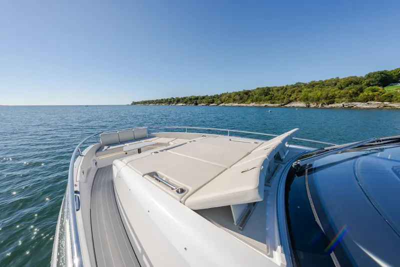 Slide: The Image of 2023 Azimut Verve 47 yacht cruising on a sunny day near a lush coastline. - 36