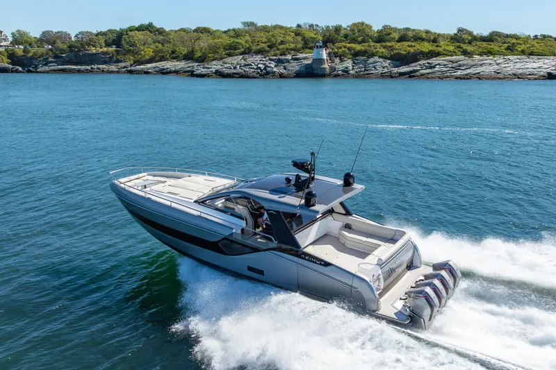 Slide: The Image of 2023 Azimut Verve 47 yacht cruising on blue water near rocky shoreline. - 39