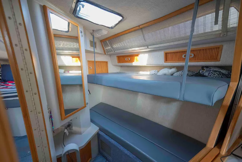 Slide: The Image of Interior cabin of 1991 Sea Ray 390 Express Cruiser with bunk beds and storage. - 20