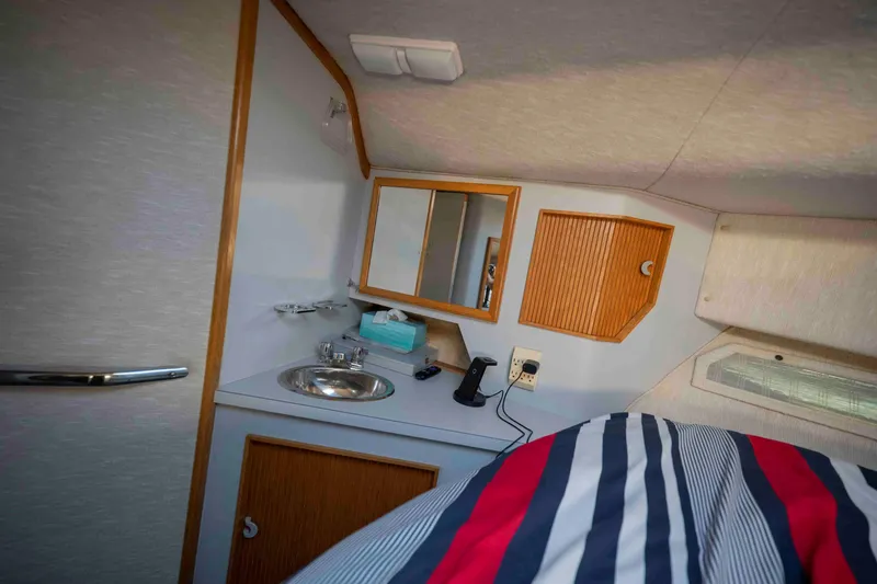 Slide: The Image of Interior cabin of 1991 Sea Ray 390 Express Cruiser with sink and storage. - 25
