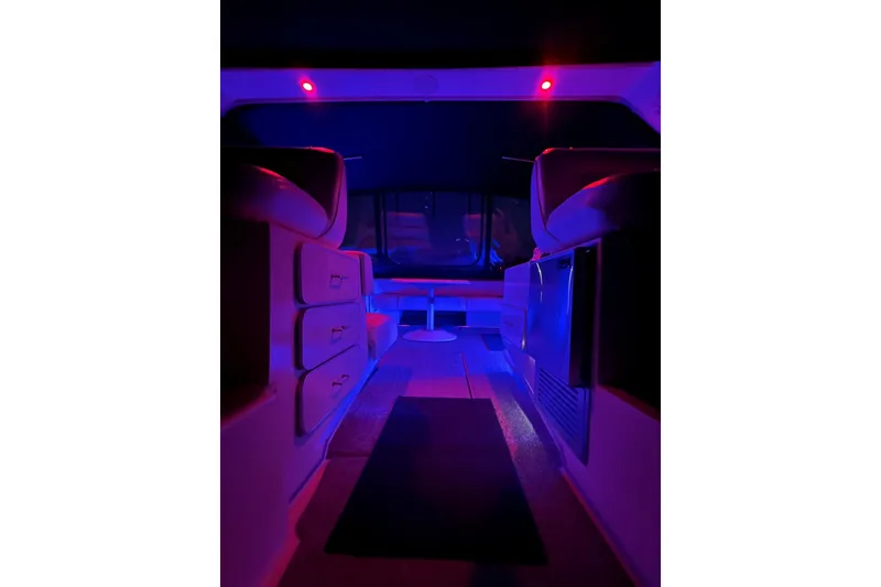 Slide: The Image of Interior of 1991 Sea Ray 390 Express Cruiser with ambient blue and red lighting. - 29