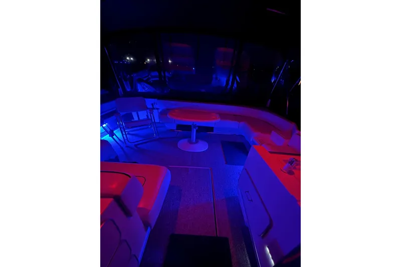 Slide: The Image of 1991 Sea Ray 390 Express Cruiser interior with ambient blue and red lighting. - 30