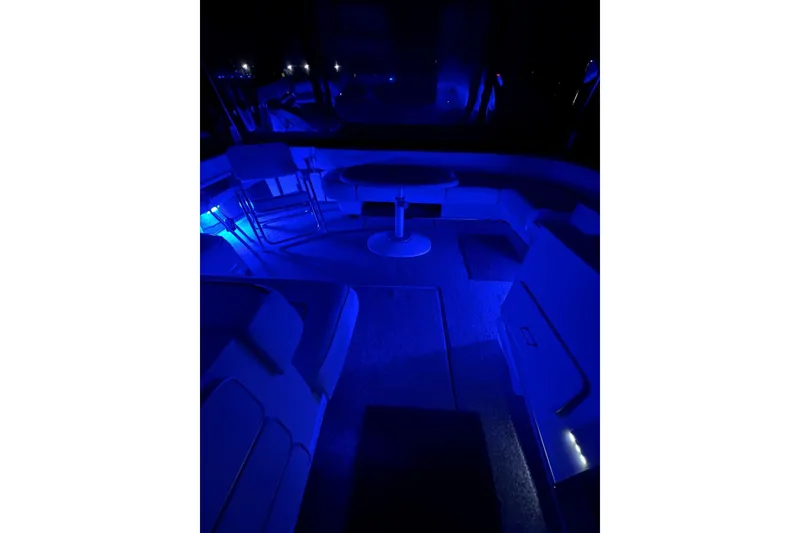 Slide: The Image of 1991 Sea Ray 390 Express Cruiser interior with blue ambient lighting at night. - 31