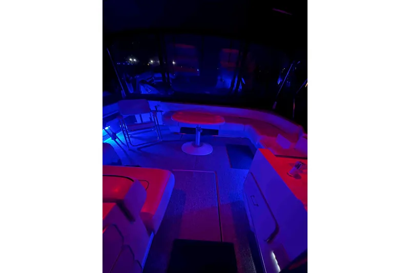 Slide: The Image of 1991 Sea Ray 390 Express Cruiser interior with ambient blue and red lighting. - 32