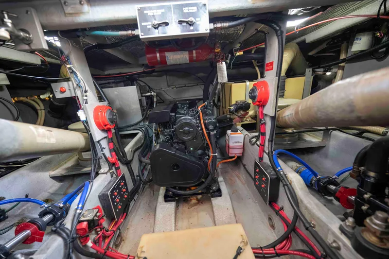 Slide: The Image of Engine room of a 1991 Sea Ray 390 Express Cruiser, showcasing mechanical components and wiring. - 34