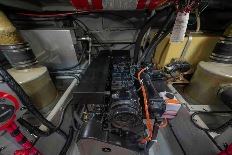 Slide: The Image of Engine room of a 1991 Sea Ray 390 Express Cruiser, showcasing mechanical components. - 35