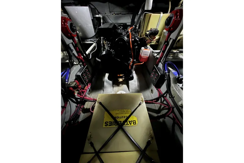 Slide: The Image of Engine room of a 1991 Sea Ray 390 Express Cruiser with visible battery and wiring. - 39
