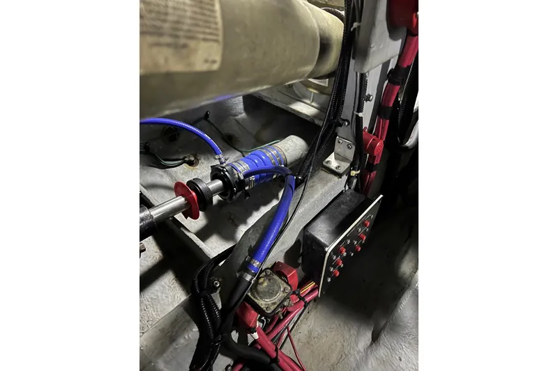 Slide: The Image of Engine compartment of a 1991 Sea Ray 390 Express Cruiser with visible wiring and components. - 40